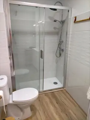 a bathroom with a shower and a toilet at Apartamento Lola Home in Sanlúcar de Barrameda