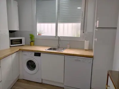a kitchen with a sink and a washing machine at Apartamento Lola Home in Sanlúcar de Barrameda