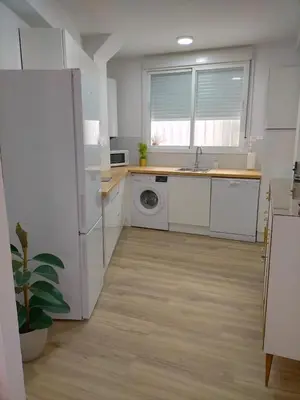 a kitchen with a refrigerator and a washing machine at Apartamento Lola Home in Sanlúcar de Barrameda