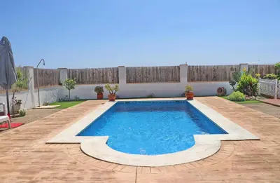 a swimming pool in the middle of a yard at Chalet Arroyo in Conil de la Frontera