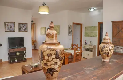 two vases sitting on a table in a living room at Chalet Arroyo in Conil de la Frontera