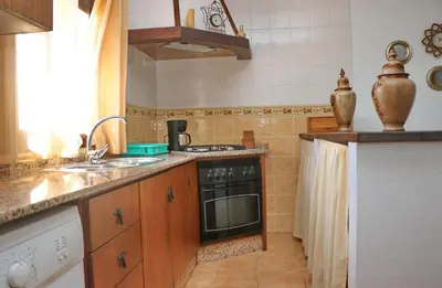 a kitchen with a sink and a stove top oven at Chalet Arroyo in Conil de la Frontera