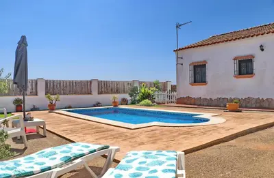a swimming pool in the backyard of a house at Chalet Arroyo in Conil de la Frontera