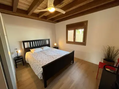 a bedroom with a bed and a ceiling fan at Villas Magnolia y Brezo in Chiclana de la Frontera