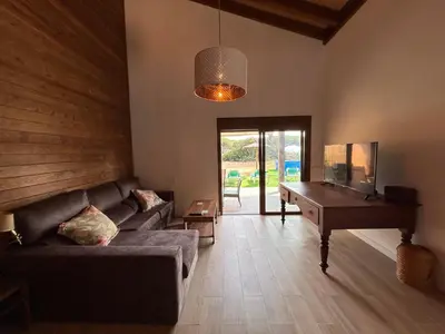 a living room with a couch and a piano at Villas Magnolia y Brezo in Chiclana de la Frontera