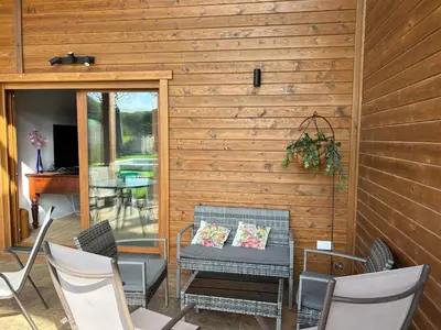 a patio with chairs and a table at Villas Magnolia y Brezo in Chiclana de la Frontera