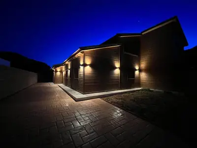 a building with lights on the side of it at night at Villas Magnolia y Brezo in Chiclana de la Frontera