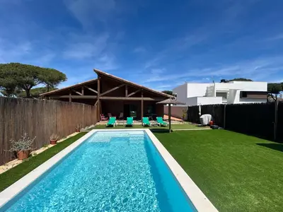 a swimming pool in the backyard of a house at Villas Magnolia y Brezo in Chiclana de la Frontera