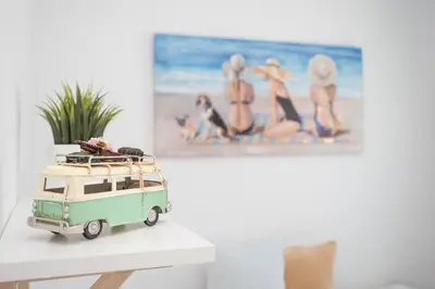 a toy van sitting on a table in front of a painting at Ático con terraza La Venencia in Sanlúcar de Barrameda