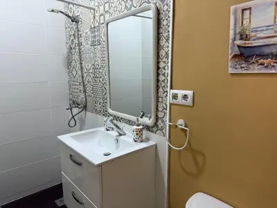 a bathroom with a sink and a mirror at Salmedina in Sanlúcar de Barrameda