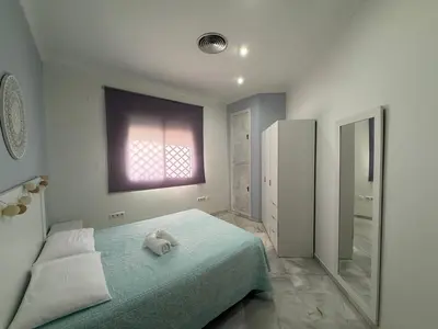 a bedroom with a bed with a towel on it at Salmedina in Sanlúcar de Barrameda