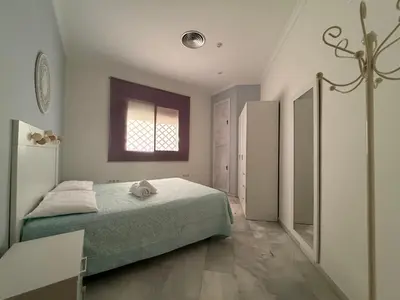 a bedroom with a bed and a window at Salmedina in Sanlúcar de Barrameda