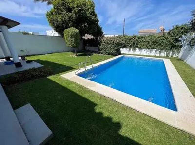 a swimming pool in the yard of a house at APOLO in Chiclana de la Frontera