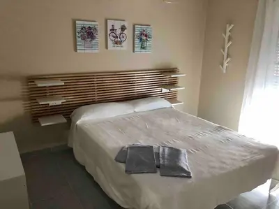 a bedroom with a bed with two towels on it at APOLO in Chiclana de la Frontera