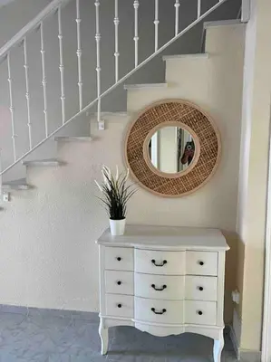a room with a dresser and a mirror and stairs at APOLO in Chiclana de la Frontera