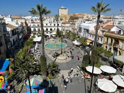 an aerial view of a city with a fountain and buildings at Aires de Doñana. Piscina y Playa. Parking gratis. in Sanlúcar de Barrameda
