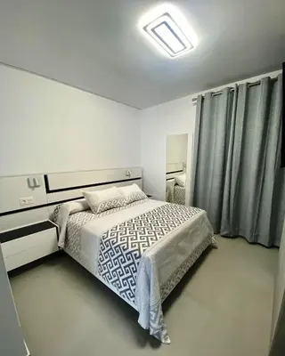 a bedroom with a bed in a room with curtains at LOFT VILLALUCIA in Conil de la Frontera