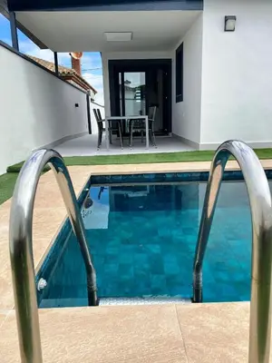a pool with metal railings in front of a house at LOFT VILLALUCIA in Conil de la Frontera