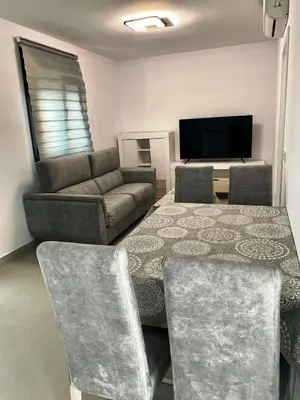 a living room with a couch and a flat screen tv at LOFT VILLALUCIA in Conil de la Frontera