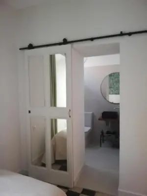 a sliding glass door in a bedroom with a bed at Apartamento Arco´s House in Sanlúcar de Barrameda