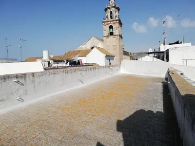 a view of a building with a clock tower at Apartamento Arco´s House in Sanlúcar de Barrameda