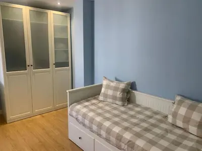 a bedroom with a bed with a cabinet and two pillows at Ribeira en Playa Victoria Grupo AC Gestion in Cádiz