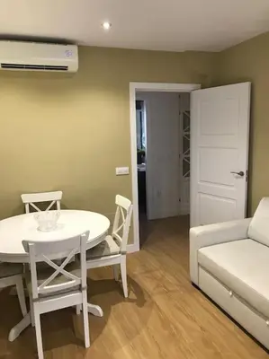 a living room with a table and a couch at Ribeira en Playa Victoria Grupo AC Gestion in Cádiz