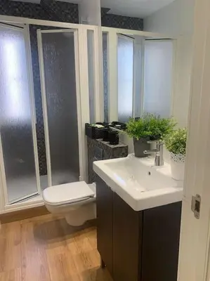 a bathroom with a toilet and a sink at Ribeira en Playa Victoria Grupo AC Gestion in Cádiz
