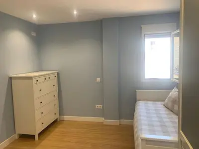 a bedroom with a bed and a dresser and a window at Ribeira en Playa Victoria Grupo AC Gestion in Cádiz