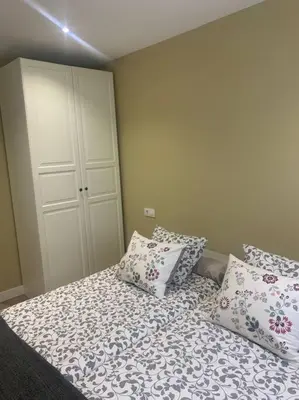 a bedroom with a bed with pillows and a closet at Ribeira en Playa Victoria Grupo AC Gestion in Cádiz