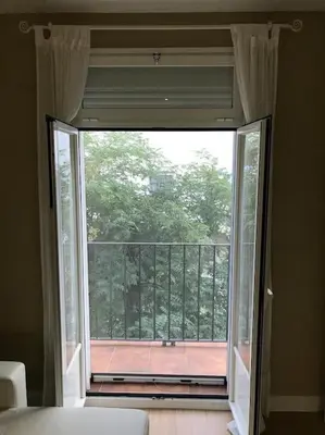 a large window in a room with a view of a balcony at Ribeira en Playa Victoria Grupo AC Gestion in Cádiz