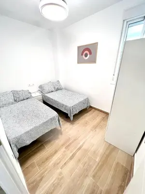 a white room with a bed and a couch at Tía Norica - Centro Cádiz in Cádiz