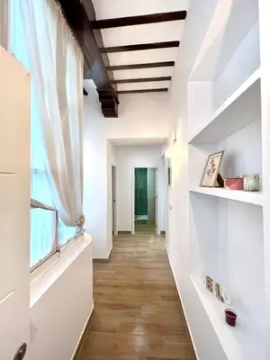 a hallway with white walls and a window at Tía Norica - Centro Cádiz in Cádiz