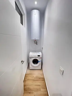 a hallway with a washer and dryer in a room at Tía Norica - Centro Cádiz in Cádiz