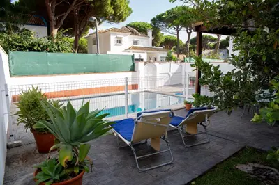 a patio with chairs and a swimming pool at Poniente in Roche