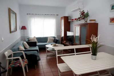 a living room with a blue couch and a table at Poniente in Roche