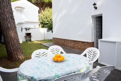 a table and chairs with a bowl of oranges on it at Poniente in Roche