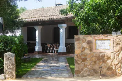 a stone walkway leading to a house with a sign at CASA CHOCOLATE in Malcocinado