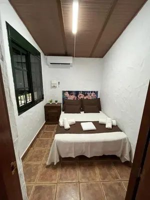 a bedroom with a large bed in a room at CASA CHOCOLATE in Malcocinado
