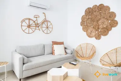 a living room with a couch and a bicycle on the wall at Apartamento Bike by LiveWork in Cádiz