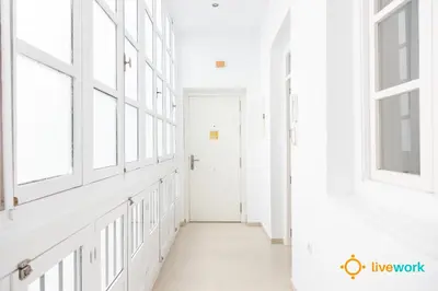 a hallway with windows and a white door at Apartamento Bike by LiveWork in Cádiz