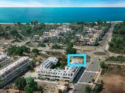 an aerial view of a building near the ocean at ÁTICOS ROTA Punta Candor in Rota