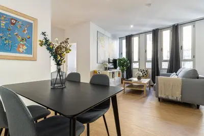 a living room with a table and a couch at Allo Apartments Santa Maria II Centro 2 Habitaciones in Jerez de la Frontera