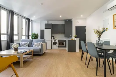 a living room with a couch and a table at Allo Apartments Santa Maria II Centro 2 Habitaciones in Jerez de la Frontera