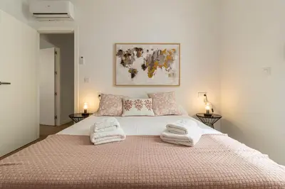a bedroom with a large bed with towels on it at Allo Apartments Santa Maria II Centro 2 Habitaciones in Jerez de la Frontera