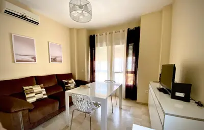 a living room with a couch and a table at MyChoice Meninas in Rota