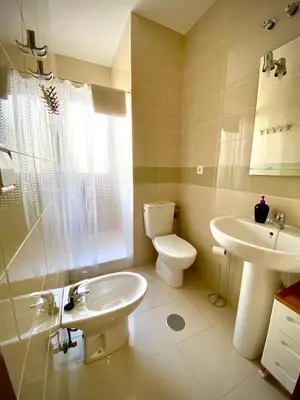 a bathroom with a toilet and a sink at MyChoice Meninas in Rota