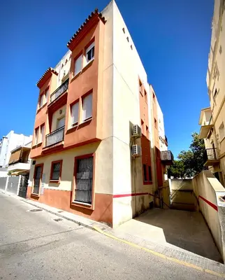 a orange and white building on a street at MyChoice Meninas in Rota