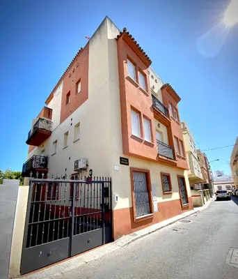 a building with a gate in front of a street at MyChoice Meninas in Rota