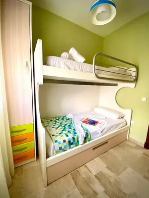 a small bedroom with two bunk beds in it at MyChoice Meninas in Rota